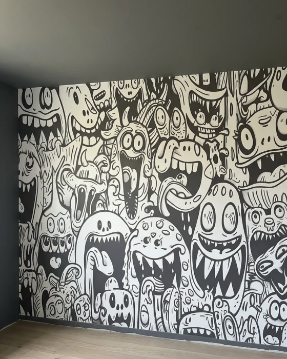 Mural ścienny w stylu komiksowym – czarno-białe potworki z dużymi zębami i wyrazistymi twarzami